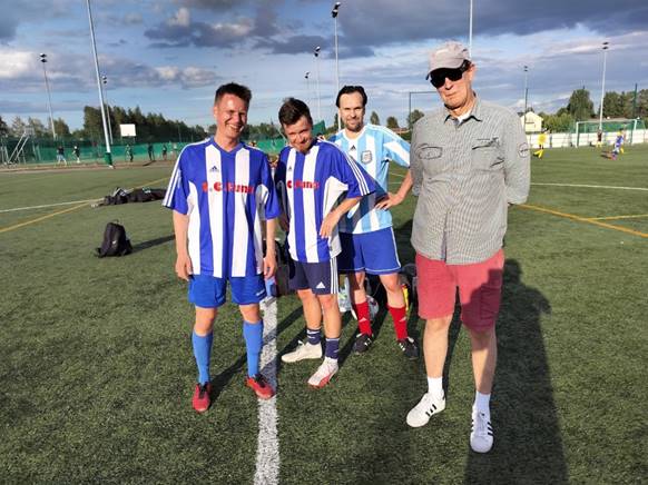 A group of men in sports uniforms on a field

Description automatically generated